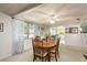 Charming dining room featuring a hardwood table and bright natural light from the large window at 6905 El Camino Paloma St, Port Richey, FL 34668