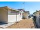 Rear exterior of the house featuring low-maintenance gravel and convenient outdoor storage at 6905 El Camino Paloma St, Port Richey, FL 34668