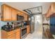 Efficient kitchen with stainless steel appliances, granite countertops, and warm maple cabinetry at 6905 El Camino Paloma St, Port Richey, FL 34668
