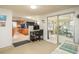 Functional office space with built-in desk and seamless access to kitchen and adjacent enclosed porch at 6905 El Camino Paloma St, Port Richey, FL 34668