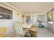 Enclosed porch with a dining table and seating, ideal for enjoying the outdoors in comfort at 6905 El Camino Paloma St, Port Richey, FL 34668