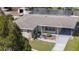 Aerial view of a well-maintained home featuring a nice yard and a charming covered entry at 8006 N Ola Ave, Tampa, FL 33604