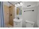 Bathroom with neutral tile in the shower, and a white sink and toilet at 8006 N Ola Ave, Tampa, FL 33604