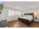 Comfortable bedroom with hardwood floors, a ceiling fan, and neutral walls at 8006 N Ola Ave, Tampa, FL 33604