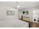 Bright bedroom featuring hardwood floors, a ceiling fan, and a wall-mounted television at 8006 N Ola Ave, Tampa, FL 33604