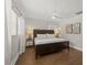 Cozy bedroom with hardwood floors, a ceiling fan, and a side window at 8006 N Ola Ave, Tampa, FL 33604