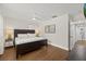 Comfortable bedroom features hardwood floors, a ceiling fan, and neutral walls at 8006 N Ola Ave, Tampa, FL 33604