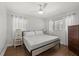 Bright bedroom with hardwood floors, a ceiling fan, and a side window at 8006 N Ola Ave, Tampa, FL 33604