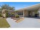 Inviting home featuring a covered entryway with stone accents and a well-maintained landscape at 8006 N Ola Ave, Tampa, FL 33604