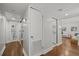 Bright hallway with hardwood floors leads to the bathroom, living room, and kitchen at 8006 N Ola Ave, Tampa, FL 33604