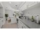 Bright, modern kitchen with stainless steel appliances, white cabinetry and eat-in breakfast nook at 8006 N Ola Ave, Tampa, FL 33604
