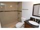 Bathroom featuring tiled walk-in shower, vanity with dark countertop, and a framed mirror at 8647 Mallard Reserve Dr # 104, Tampa, FL 33614