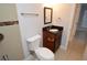 Bathroom with dark vanity, mirror, and white toilet at 8647 Mallard Reserve Dr # 104, Tampa, FL 33614