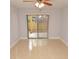 Bedroom with tiled floor, sliding glass door to outdoor patio, and ceiling fan at 8647 Mallard Reserve Dr # 104, Tampa, FL 33614