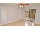 Bedroom with tiled floor, sliding glass door to outdoor patio, and ceiling fan at 8647 Mallard Reserve Dr # 104, Tampa, FL 33614