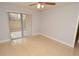 Bedroom with tiled floor, sliding glass door to outdoor patio, and ceiling fan at 8647 Mallard Reserve Dr # 104, Tampa, FL 33614