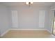 Bedroom with tiled floor, sliding glass door to outdoor patio, and two windows at 8647 Mallard Reserve Dr # 104, Tampa, FL 33614