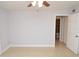 This bedroom features neutral walls, tile flooring, and a view of the bathroom at 8647 Mallard Reserve Dr # 104, Tampa, FL 33614