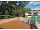 Community deck with vinyl railing overlooking tropical landscaping and tennis court at 8647 Mallard Reserve Dr # 104, Tampa, FL 33614