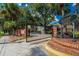 Grand Reserve Condominiums entrance gate with brick accents and mature landscaping at 8647 Mallard Reserve Dr # 104, Tampa, FL 33614