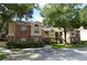 Brick and siding exterior with mature landscaping, creating a welcoming curb appeal for this condo complex at 8647 Mallard Reserve Dr # 104, Tampa, FL 33614