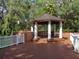 Community gazebo with vinyl railing overlooking lush tropical landscaping at 8647 Mallard Reserve Dr # 104, Tampa, FL 33614
