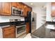 Kitchen features stainless steel appliances, granite countertops, and rich wood cabinetry at 8647 Mallard Reserve Dr # 104, Tampa, FL 33614