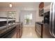 Charming kitchen with stainless steel appliances, tile floors and dark cabinets at 8647 Mallard Reserve Dr # 104, Tampa, FL 33614