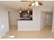 Open-concept living room with tile flooring, ceiling fan, and a view of the kitchen at 8647 Mallard Reserve Dr # 104, Tampa, FL 33614