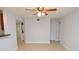 Neutral living room with tile floors, ceiling fan, and an open doorway to a laundry area at 8647 Mallard Reserve Dr # 104, Tampa, FL 33614