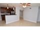Open concept living space with modern kitchen featuring stainless steel appliances and tile flooring at 8647 Mallard Reserve Dr # 104, Tampa, FL 33614