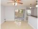 Open living area with tile flooring and sliding glass doors leading to the outside patio at 8647 Mallard Reserve Dr # 104, Tampa, FL 33614