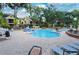 Beautiful swimming pool area with jacuzzi, lounge chairs, and well-maintained brick patio near buildings at 8647 Mallard Reserve Dr # 104, Tampa, FL 33614