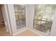 Light-filled room with tile floor, two windows, and neutral colored walls at 8647 Mallard Reserve Dr # 104, Tampa, FL 33614