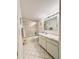 Bathroom with a shower and tub combination, white vanity, and tile floor, providing a clean aesthetic at 946 Virgina # 304, Dunedin, FL 34698