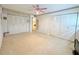 Bedroom featuring dual closets, neutral carpet, and a view into the hallway, offering ample storage at 946 Virgina # 304, Dunedin, FL 34698