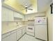 Kitchen with white appliances and a drop ceiling at 946 Virgina # 304, Dunedin, FL 34698