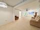 View of the spacious living room with light carpet and couch, connecting to the entry and other rooms at 946 Virgina # 304, Dunedin, FL 34698