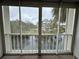 Patio with serene pond view, surrounded by lush trees, offering tranquil outdoor living space at 946 Virgina # 304, Dunedin, FL 34698