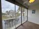 Screened patio with a view of pond and surrounding trees, with ceiling fan, creating outdoor serenity at 946 Virgina # 304, Dunedin, FL 34698