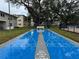 Outdoor shuffleboard court in a community, with buildings in the background and mature trees providing shade at 946 Virgina # 304, Dunedin, FL 34698