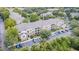 Aerial view of condo complex featuring lush landscaping, ample parking, and well-maintained buildings at 10205 Courtney Palms Blvd # 304, Tampa, FL 33619