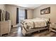 Cozy bedroom featuring a comfortable bed with stylish bedding, a dresser, and neutral décor at 10205 Courtney Palms Blvd # 304, Tampa, FL 33619