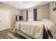 Cozy bedroom with a comfortable bed, sleek wood floors, and a large window for natural light at 10205 Courtney Palms Blvd # 304, Tampa, FL 33619