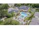 A relaxing pool area with lush landscaping, lounge chairs, and umbrellas, perfect for enjoying the Florida sunshine at 10205 Courtney Palms Blvd # 304, Tampa, FL 33619
