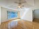 Bright bedroom featuring hardwood floors and a window providing natural light at 1042 Trafalgar Dr, New Port Richey, FL 34655