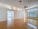 Spacious living room boasting hardwood floors, recessed lighting, fan, and natural light from clerestory windows at 1042 Trafalgar Dr, New Port Richey, FL 34655