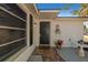 Elegant front door with decorative details, a brick pathway, and potted plants for added charm at 11338 Yellowwood Ln, Port Richey, FL 34668