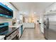 Spacious kitchen with white cabinetry, stainless steel appliances, and an open layout leading to other rooms at 11338 Yellowwood Ln, Port Richey, FL 34668