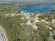Picturesque aerial view of lakeside homes nestled among trees, offering a tranquil living environment at 12005 Wren Ct, New Port Richey, FL 34654